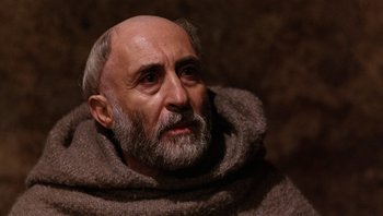 Movie still from “The Name of the Rose” (1986), directed by Jean-Jacques Annaud – An old man with a long beard and a gray beard; Close Up shot, High angle