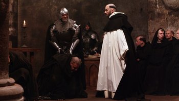 Movie still from “The Name of the Rose” (1986), directed by Jean-Jacques Annaud – A group of people dressed in medieval garb; Wide shot, High angle