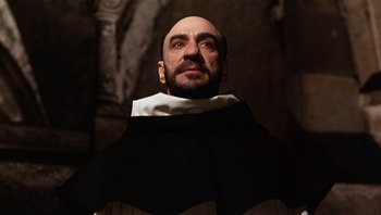Movie still from “The Name of the Rose” (1986), directed by Jean-Jacques Annaud – A man with a bald head wearing a black and white outfit; Close Up shot, Low angle