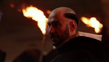 Movie still from “The Name of the Rose” (1986), directed by Jean-Jacques Annaud – A man with a bald head is looking to his left; Close Up shot, Low angle