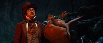 Movie still from “The NeverEnding Story” (1984), directed by Wolfgang Petersen – A man standing next to a statue of a man and a frog; Medium shot, Low angle