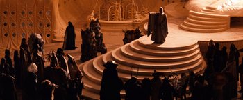 Movie still from “The NeverEnding Story” (1984), directed by Wolfgang Petersen – A group of people standing on top of a spiral staircase; Wide shot, High angle