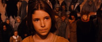 Movie still from “The NeverEnding Story” (1984), directed by Wolfgang Petersen – A young girl in front of a group of people; Close Up shot, High angle
