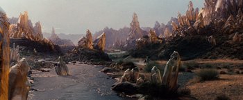 Movie still from “The NeverEnding Story” (1984), directed by Wolfgang Petersen – A man standing next to a body of water; Extreme Wide shot, High angle