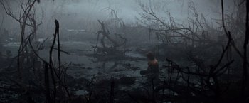 Movie still from “The NeverEnding Story” (1984), directed by Wolfgang Petersen – A man sitting in a swamp in the middle of the night; Extreme Wide shot, High angle