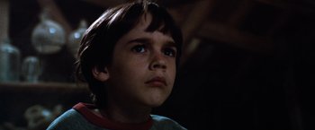 Movie still from “The NeverEnding Story” (1984), directed by Wolfgang Petersen – A young boy is looking up at the sky; Close Up shot, Low angle