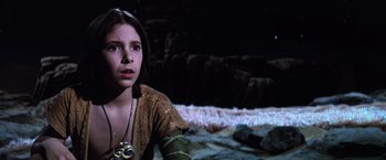 Movie still from “The NeverEnding Story” (1984), directed by Wolfgang Petersen – A young woman is looking into the distance; Close Up shot, High angle