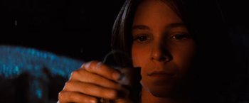 Movie still from “The NeverEnding Story” (1984), directed by Wolfgang Petersen – A woman is holding a cigarette in her hand; Close Up shot, Low angle