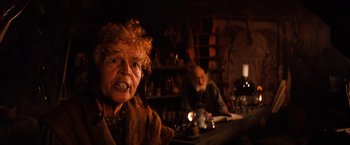 Movie still from “The NeverEnding Story” (1984), directed by Wolfgang Petersen – An old woman with a surprised look on her face; Close Up shot, Over the shoulder angle