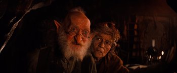 Movie still from “The NeverEnding Story” (1984), directed by Wolfgang Petersen – An older man and woman dressed in costume for halloween; Close Up shot, Low angle
