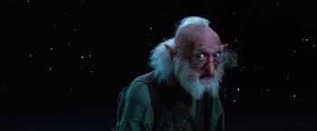 Movie still from “The NeverEnding Story” (1984), directed by Wolfgang Petersen – An old man with white hair and a long beard; Close Up shot, Low angle