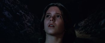Movie still from “The NeverEnding Story” (1984), directed by Wolfgang Petersen – A young woman looking up into the dark sky; Close Up shot, Low angle