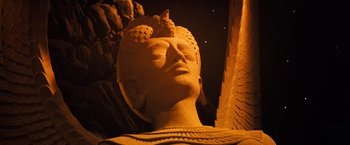 Movie still from “The NeverEnding Story” (1984), directed by Wolfgang Petersen – A statue of a person with a bird perched on its head; Close Up shot, Low angle