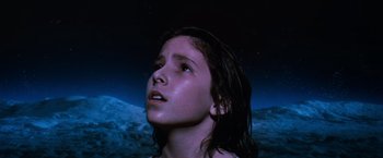 Movie still from “The NeverEnding Story” (1984), directed by Wolfgang Petersen – A young girl looking up into the night sky; Close Up shot, Low angle