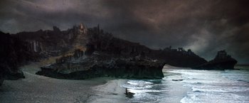 Movie still from “The NeverEnding Story” (1984), directed by Wolfgang Petersen – A person on a surfboard in the water; Extreme Wide shot, High angle
