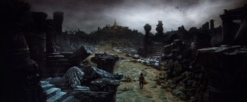 Movie still from “The NeverEnding Story” (1984), directed by Wolfgang Petersen – A painting of a man walking through a desolate landscape; Extreme Wide shot, High angle