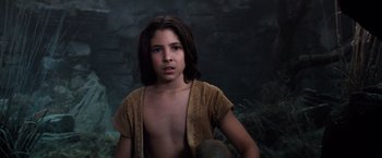 Movie still from “The NeverEnding Story” (1984), directed by Wolfgang Petersen – A young boy is posing for a picture; Medium shot, Low angle