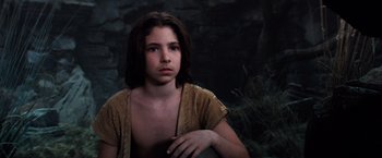 Movie still from “The NeverEnding Story” (1984), directed by Wolfgang Petersen – A young girl is sitting in front of a tree; Close Up shot, Low angle