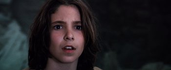 Movie still from “The NeverEnding Story” (1984), directed by Wolfgang Petersen – A person with long brown hair; Close Up shot, Low angle