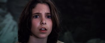 Movie still from “The NeverEnding Story” (1984), directed by Wolfgang Petersen – A person with long brown hair; Close Up shot, Low angle