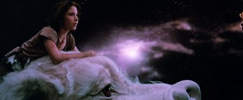 Movie still from “The NeverEnding Story” (1984), directed by Wolfgang Petersen – A woman sitting on top of a white bear; Medium shot, Low angle