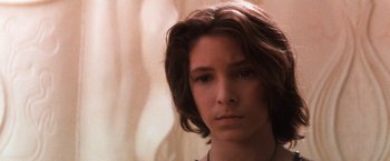 Movie still from “The NeverEnding Story” (1984), directed by Wolfgang Petersen – A person with long brown hair; Close Up shot, Low angle