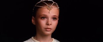 Movie still from “The NeverEnding Story” (1984), directed by Wolfgang Petersen – A young woman wearing a head piece with pearls; Close Up shot, High angle