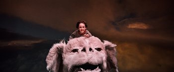 Movie still from “The NeverEnding Story” (1984), directed by Wolfgang Petersen – A young boy sitting on top of a stuffed animal; Wide shot, High angle