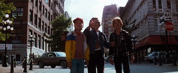 Movie still from “The NeverEnding Story” (1984), directed by Wolfgang Petersen – A group of people walking down a street; Medium shot, Low angle