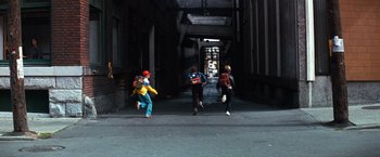 Movie still from “The NeverEnding Story” (1984), directed by Wolfgang Petersen – A group of people walking down a street; Extreme Wide shot, High angle