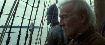 Movie still from “The New World” (2005), directed by Terrence Malick – Two men in medieval costumes on a boat; Close Up shot, Over the shoulder angle