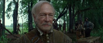 Movie still from “The New World” (2005), directed by Terrence Malick – An old man with white hair and a beard in the woods; Close Up shot, Low angle