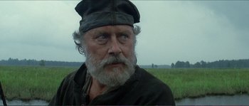Movie still from “The New World” (2005), directed by Terrence Malick – An old man with a beard wearing a hat; Close Up shot, Over the shoulder angle
