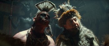 Movie still from “The New World” (2005), directed by Terrence Malick – Two native american men in traditional clothing and headdress; Close Up shot, Low angle