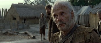Movie still from “The New World” (2005), directed by Terrence Malick – An old man with a beard is looking into the camera; Close Up shot, Over the shoulder angle