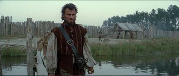 Movie still from “The New World” (2005), directed by Terrence Malick – A man standing next to a body of water; Medium shot, Low angle
