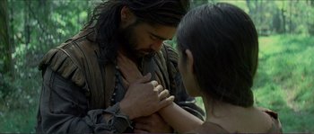 Movie still from “The New World” (2005), directed by Terrence Malick – A man and a woman are holding each other in a forest; Close Up shot, Over the shoulder angle