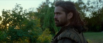 Movie still from “The New World” (2005), directed by Terrence Malick – A man with long hair and a beard looking into the distance; Close Up shot, Over the shoulder angle