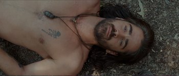 Movie still from “The New World” (2005), directed by Terrence Malick – A man laying on top of a pile of leaves; Close Up shot, Overhead angle