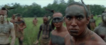Movie still from “The New World” (2005), directed by Terrence Malick – A group of people in a field with a bird flying in the background; Close Up shot, Low angle