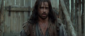 Movie still from “The New World” (2005), directed by Terrence Malick – A man with long brown hair and a beard; Close Up shot, Over the shoulder angle