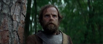 Movie still from “The New World” (2005), directed by Terrence Malick – A man with long hair and a beard wearing armor; Close Up shot, Low angle