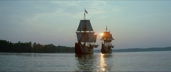 Movie still from “The New World” (2005), directed by Terrence Malick – A couple of ships are sailing on the water; Extreme Wide shot, Low angle