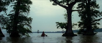 Movie still from “The New World” (2005), directed by Terrence Malick – Two people in a body of water near a tree; Extreme Wide shot, Low angle