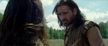 Movie still from “The New World” (2005), directed by Terrence Malick – A man with long brown hair standing next to another man; Close Up shot, Over the shoulder angle