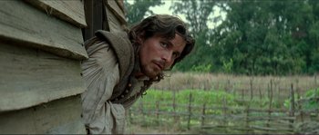 Movie still from “The New World” (2005), directed by Terrence Malick – A person with a beard; Medium shot, Over the shoulder angle