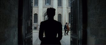 Movie still from “The New World” (2005), directed by Terrence Malick – A woman standing in front of an old building; Wide shot, Over the shoulder angle