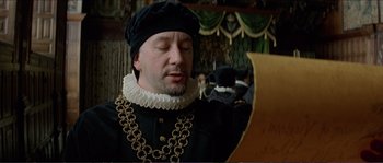 Movie still from “The New World” (2005), directed by Terrence Malick – A man wearing a black hat and a black jacket; Close Up shot, Over the shoulder angle