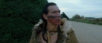 Movie still from “The New World” (2005), directed by Terrence Malick – A man with a face paint and a fur trimmed jacket; Close Up shot, Low angle
