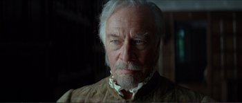 Movie still from “The New World” (2005), directed by Terrence Malick – An older man with white hair and a beard looking at the camera; Close Up shot, Low angle